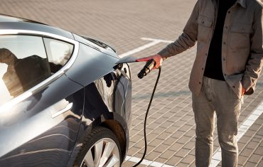 Person charging their electric vehicle